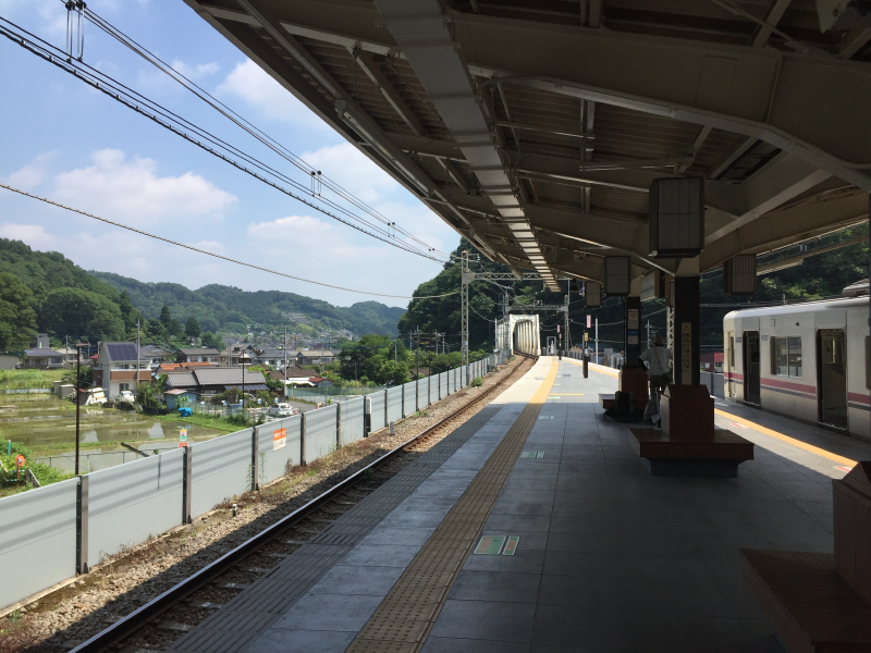 Rural train station platform with mountains