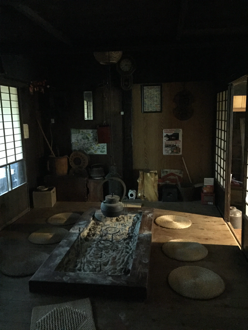 Traditional irori sunken hearth room with tea kettle