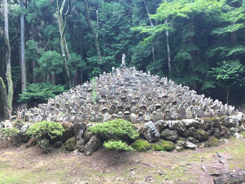 Stone Buddha statues pyramid in forest