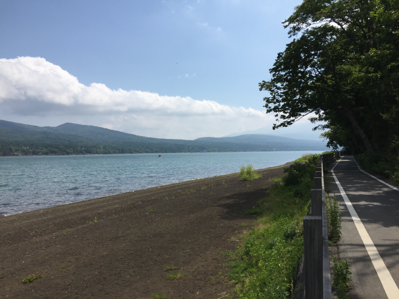 Lakeside bike path with mountains