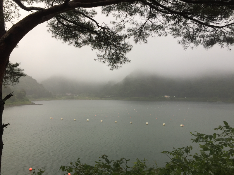 Foggy lake with mountains obscured by clouds