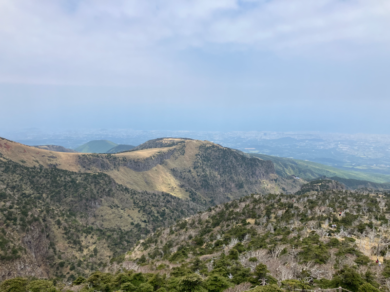Crater ridge descending toward distant valley and coast